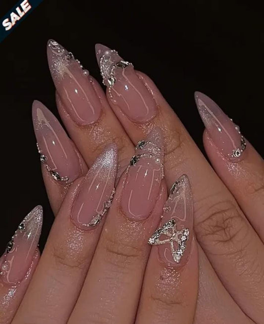 butterfly-inspired stiletto nails with a pink base, silver glitter accents, and rhine stones nails sets
